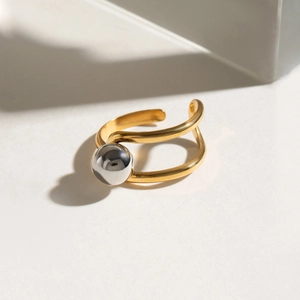 Two-tone stainless steel open ring with wavy golden lines and silver bead detail