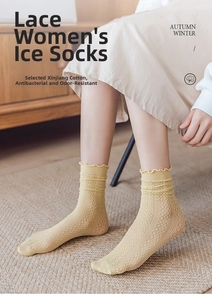 Detailed close-up of ginger yellow breathable mesh socks with elegant lettuce edge cuffs