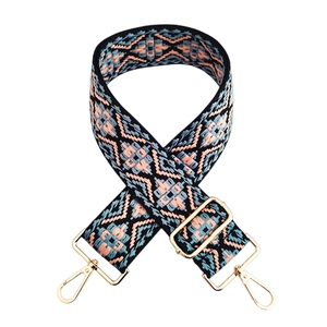 Close-up of geometric ethnic woven bag strap with pink and blue diamond patterns
