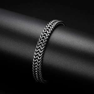 Detail of silver double-headed snake steel bracelet with antique finish on black display