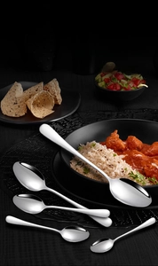 Detailed macro view of polished stainless steel pointed spoon series with mirror finish