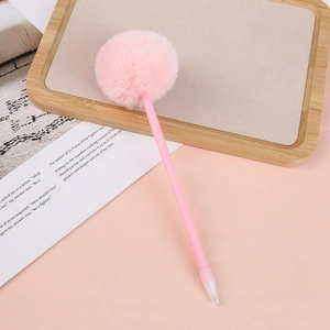 Detailed view of a pink fluffy pom-pom ball atop a creative writing stationery pen