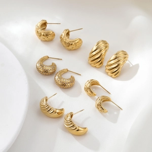 Golden vintage irregular textured earrings set with rhinestones and spiral metal details