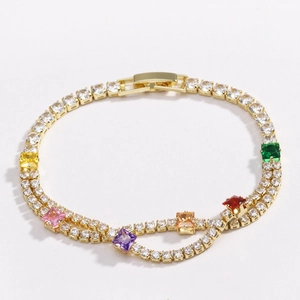 Macro detail of gold tennis bracelet with colorful square zircons and secure clasp