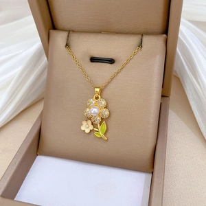 Detailed shot of flower pendant necklace with pearls and zircon in a jewelry box