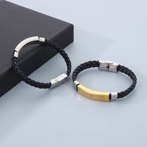 Detail of woven leather bracelets with gold and silver scripture stainless steel plates