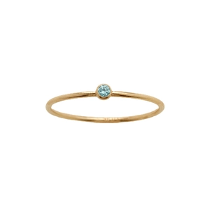 Minimalist gold ring featuring a round blue birthstone on a clean white background