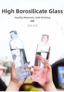 Detail of high borosilicate glass water bottles with time markers in blue and pink