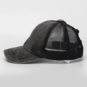 Detail of vintage washed baseball cap with breathable mesh and distressed denim texture