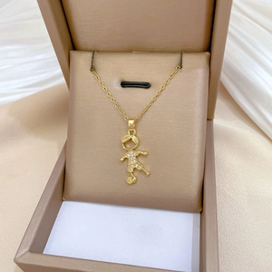 Golden titanium soccer boy pendant necklace with sparkling zircons in a jewelry box
