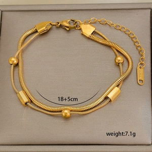 Macro detail of double-layered 18K gold-plated snake chain bracelet with S.Steel engraving