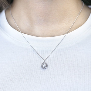 Elegant S925 sterling silver halo necklace with round clear zircon pendant on a female model