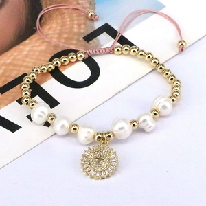 Handmade pearl bracelet with gold beads and cross pendant micro-set with cubic zirconia