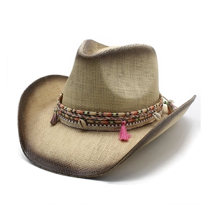 Straw western cowboy hat with seashell beads and colorful tassels on white background