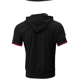 Detail view of black waffle knit polo shirt with checkered trim on sleeve cuffs