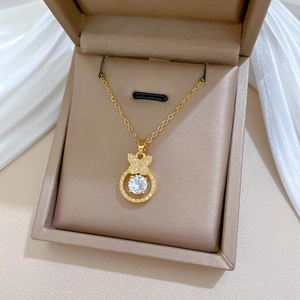 Detailed view of a gold butterfly necklace with diamonds in a jewelry box