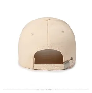 Detail of beige canvas baseball cap back showing adjustable fabric strap and metal buckle