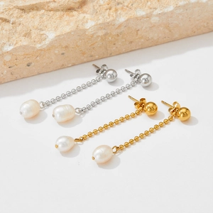 Elegant gold and silver tassel earrings with baroque pearls on a natural stone base