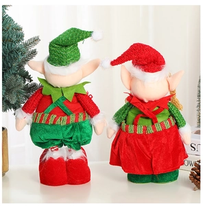 Close-up of festive Christmas elf dolls set in red and green fabric for holiday decor