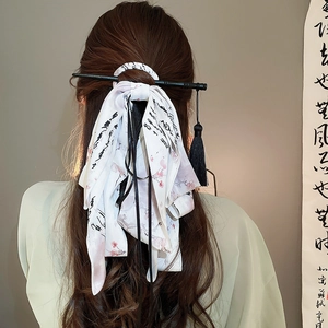 Detail of New Chinese style hair clip with ribbon and tassel on model's hair