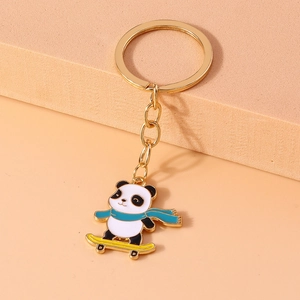 Macro shot of creative panda keychain with blue scarf on yellow skateboard ornament