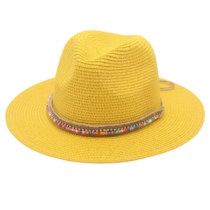Close-up of yellow straw Panama hat featuring colorful beads and rope detailing