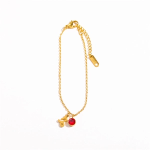 Detail of 18K gold Capricorn zodiac bracelet with ruby pendant and lobster clasp