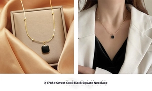 Close-up of minimalist black square pendant with gold chain on satin background