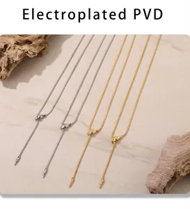 Detail of PVD electroplated snake bone chain necklaces in gold and silver finishes