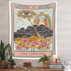 Detail of tarot style tapestry XI THE AUDACITY hanging on white wall with cozy decor