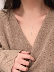Close-up of S925 silver Y-shape necklace featuring a blue waterdrop crystal pendant