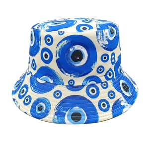 Detailed view of bucket hat with blue evil eye graffiti pattern on premium canvas