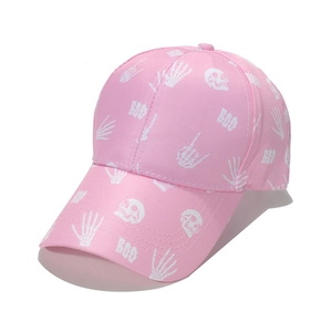 Detail of pink cotton baseball cap featuring white skull and BOO graphic prints