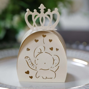Close-up of laser-cut elephant and heart candy box with a crown top on a plate