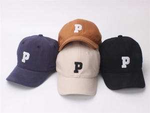 Close-up of four kids' baseball caps in navy, brown, beige, and black with P embroidery