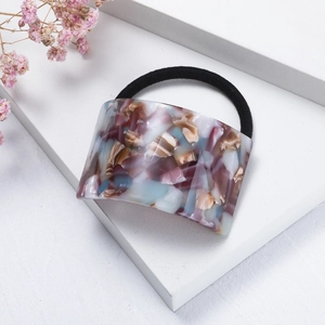Detailed macro view of the purple marble acetate hair tie with a high elastic black band