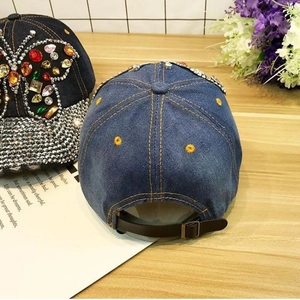 Detail of rhinestone butterfly denim baseball cap with leather adjustable buckle