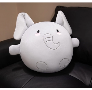 Close-up of soft grey round elephant plush toy on a premium black leather sofa