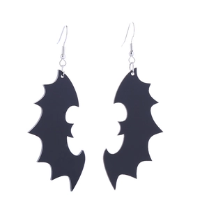 Detailed view of black bat wing earrings in gothic style on a clean white background