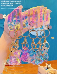 Close-up of geometric crystal bear keychains with colorful laser gradient lanyards
