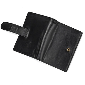 Detail view of the open black genuine leather wallet with secure metal snap closure