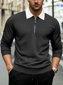 Detailed view of grey waffle knit polo shirt featuring a contrast white zipper collar