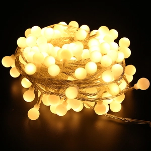 Warm white frosted ball LED fairy lights for Christmas tree decoration on dark background