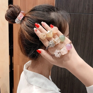 Detailed view of colorful resin crystal bead hair ties worn by a young girl