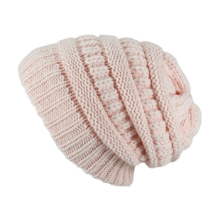Detailed macro view of pink cable knit texture and soft yarn on a slouchy winter beanie