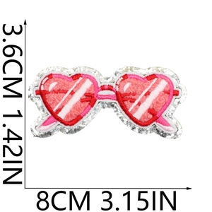 Detail of pink heart glasses patch with chenille towel embroidery and silver sequins