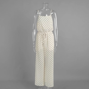 Detailed view of polka dot wide-leg jumpsuit featuring drawstring waist and spaghetti straps