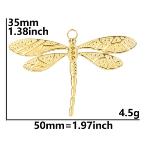 Macro shot of gold dragonfly pendant measuring 35mm by 50mm with weight of 4.5g