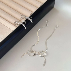 Close-up of S925 sterling silver bow jewelry set with necklace and earrings in a box