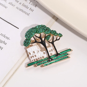 Artistic tree brooch with green rhinestones and vintage architectural design base